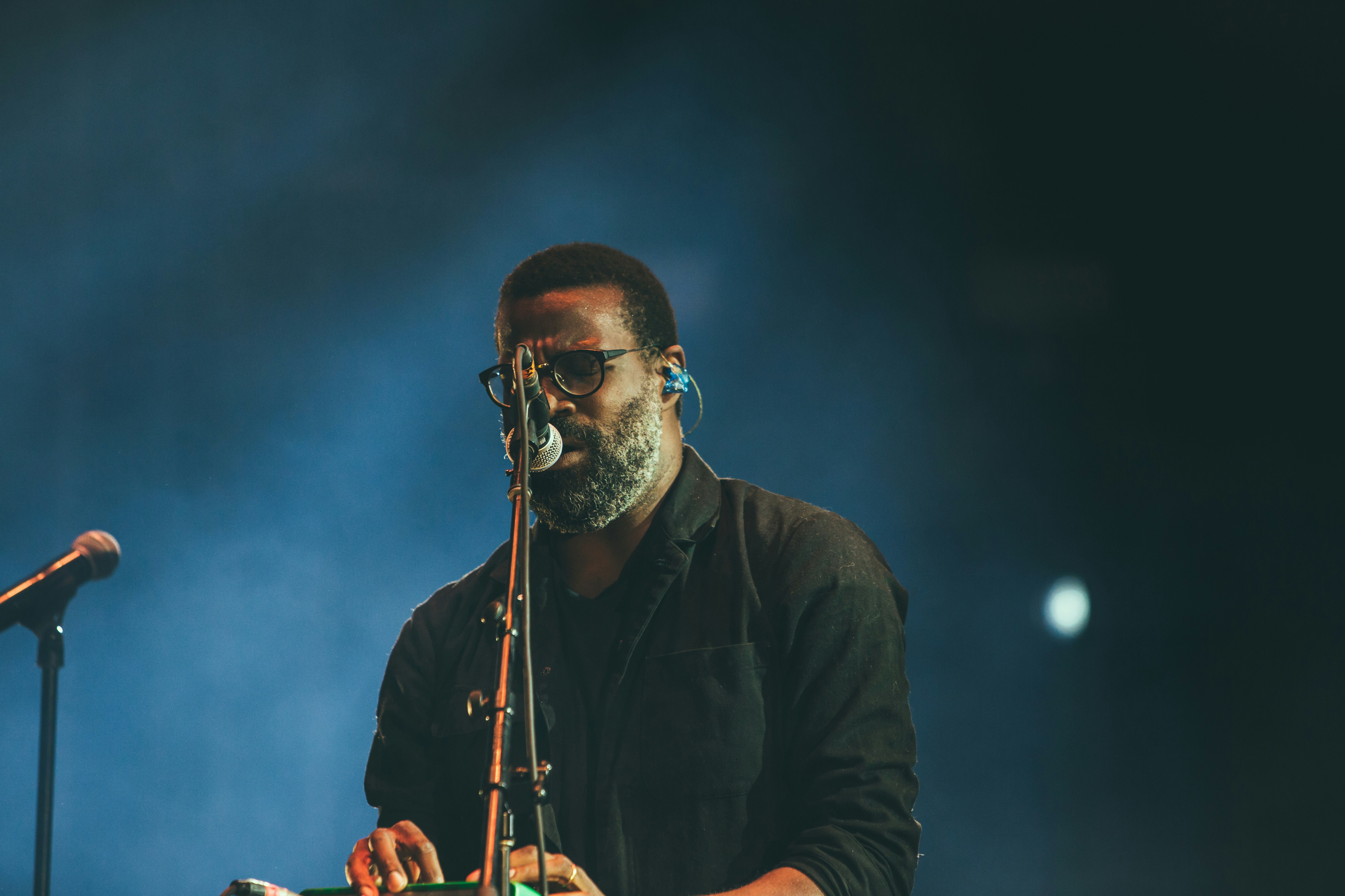 man standing facing microphone